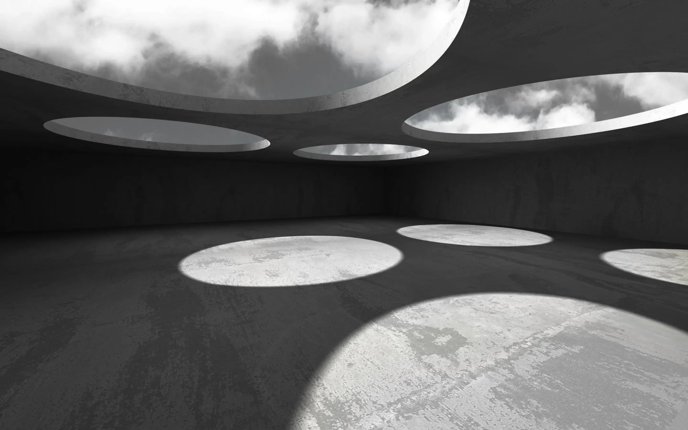Concrete room with circular ceiling openings casting light patches on the floor, with sky and clouds visible above.